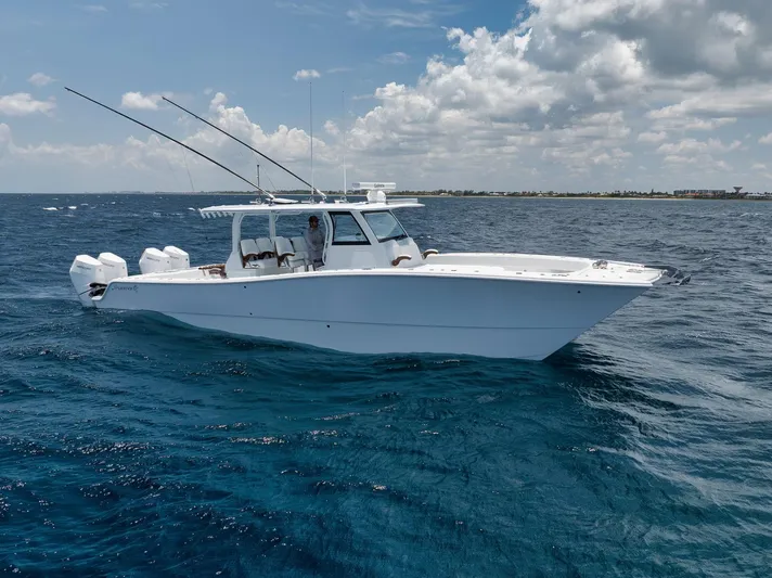 Sycorax Yacht Photos Pics 2024 Freeman 43 CC boat cruising on open ocean under cloudy sky.