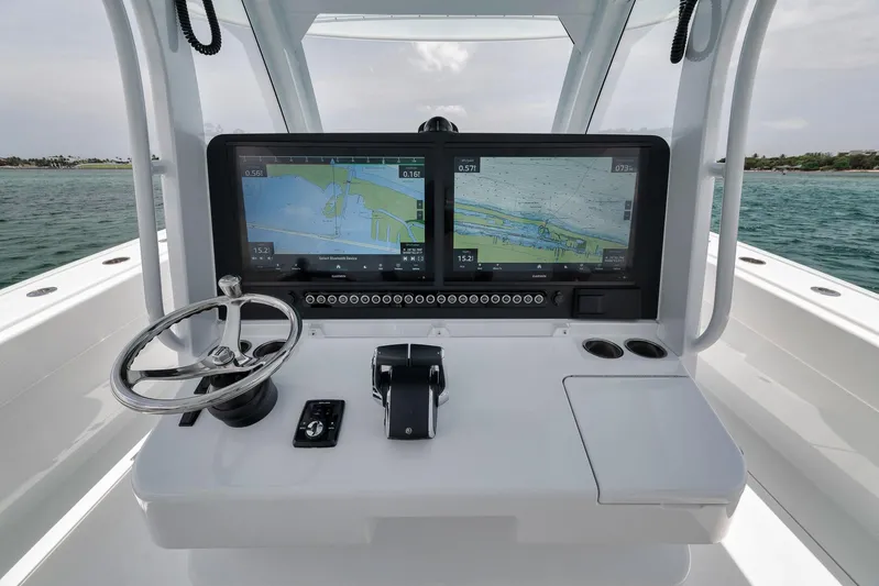 Sycorax Yacht Photos Pics 2024 Freeman 43 CC boat dashboard with dual navigation screens and steering wheel.