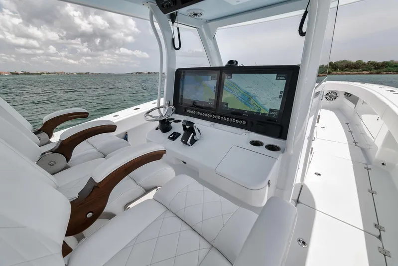 Sycorax Yacht Photos Pics 2024 Freeman 43 CC boat cockpit with dual screens and luxurious seating on open water.