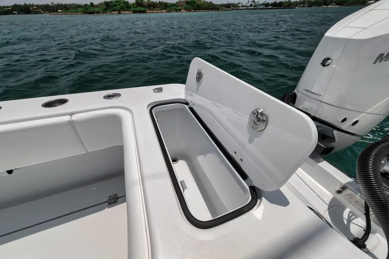 Sycorax Yacht Photos Pics 2024 Freeman 43 CC boat with open storage compartment on deck, near water.