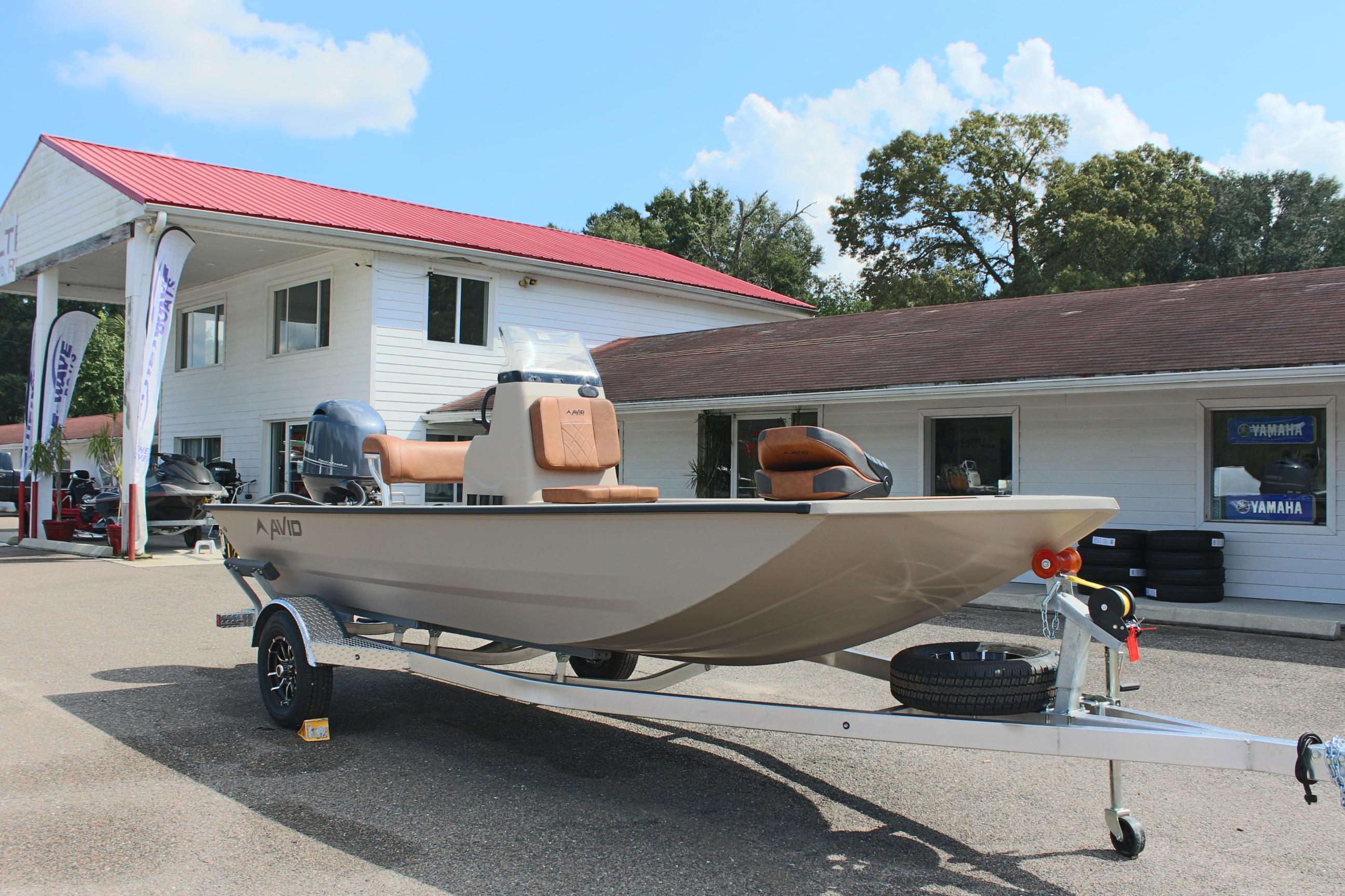 2025 Avid 18 Rogue CC boat on trailer outside dealership.