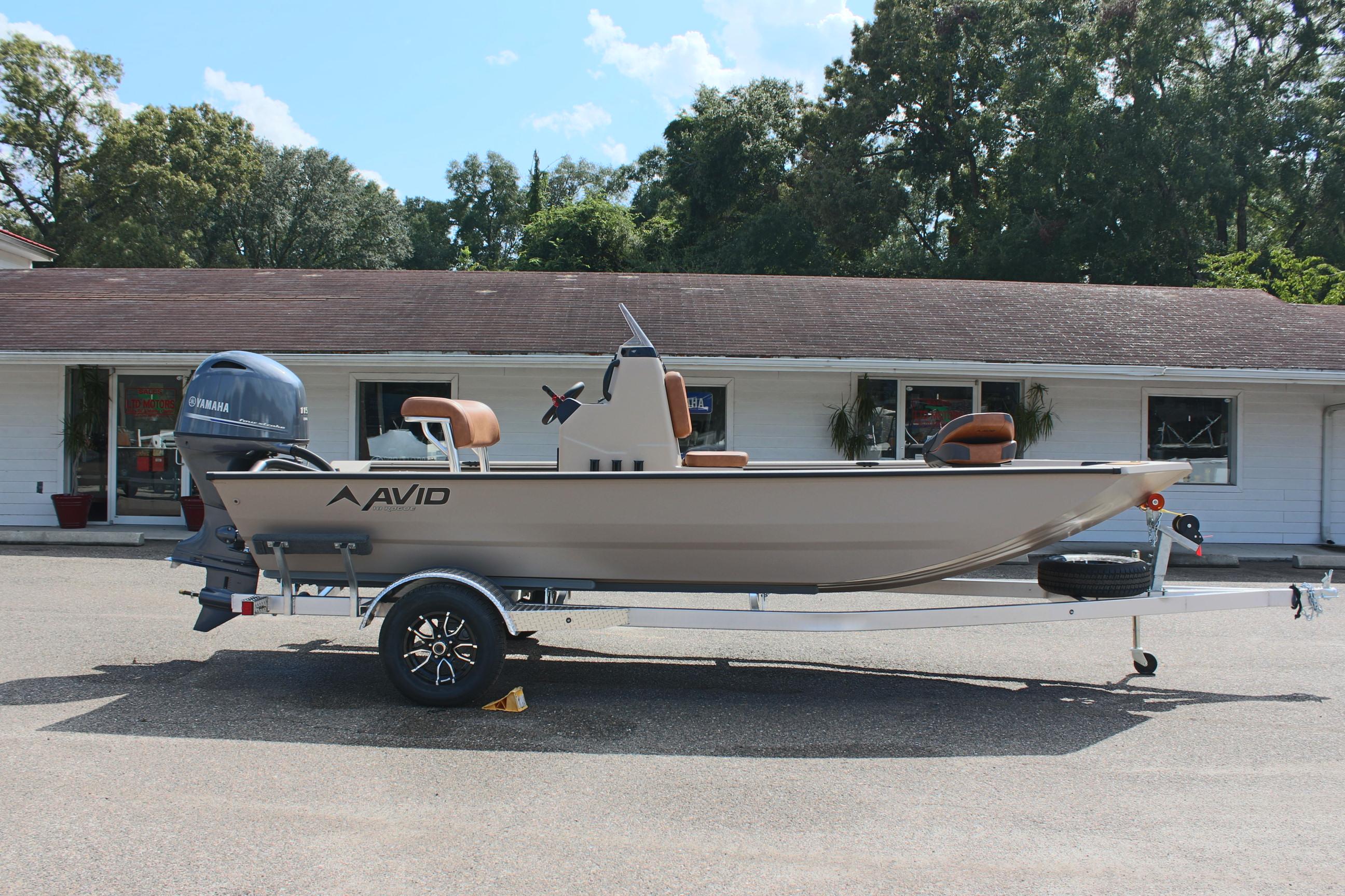 2025 Avid 18 Rogue CC boat on trailer, parked in front of building.