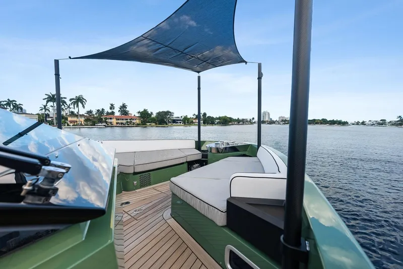 Another World Yacht Photos Pics 2025 Wally Wallytender 100 yacht with shaded deck, cruising on a serene waterway.