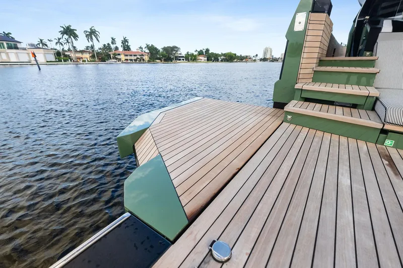 Another World Yacht Photos Pics Luxury deck of 2025 Wally Wallytender 100 yacht with scenic waterfront view.