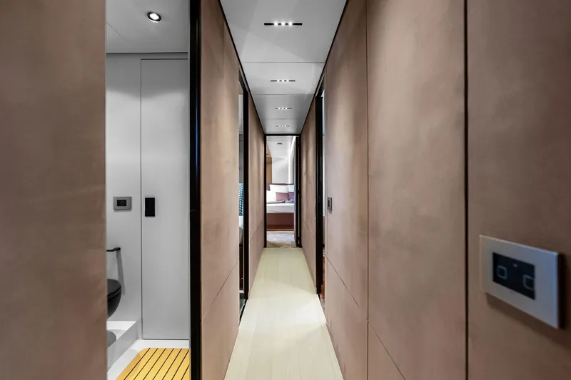 Another World Yacht Photos Pics Luxurious interior hallway of 2025 Wally Wallytender 100 yacht, featuring modern design elements.