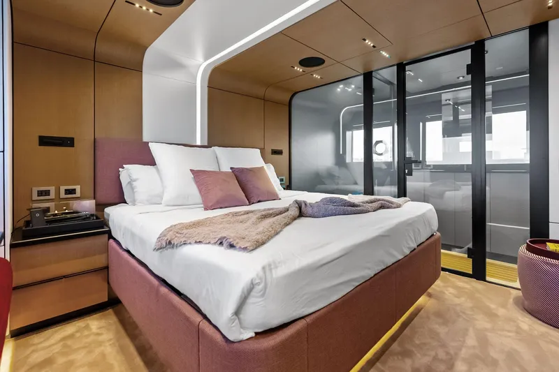 Another World Yacht Photos Pics Luxurious bedroom interior of 2025 Wally Wallytender 100 yacht with modern design elements.