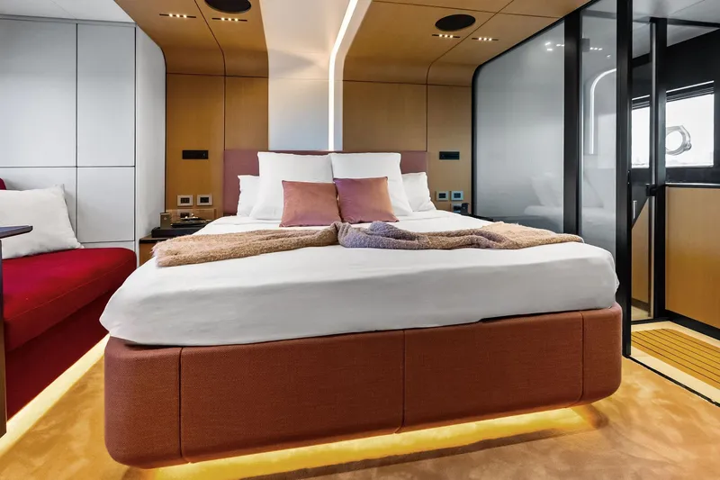 Another World Yacht Photos Pics Luxurious bedroom interior of 2025 Wally Wallytender 100 yacht with modern design and ambient lighting.