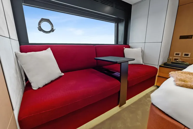 Another World Yacht Photos Pics Luxurious interior of 2025 Wally Wallytender 100 yacht with red seating and ocean view.