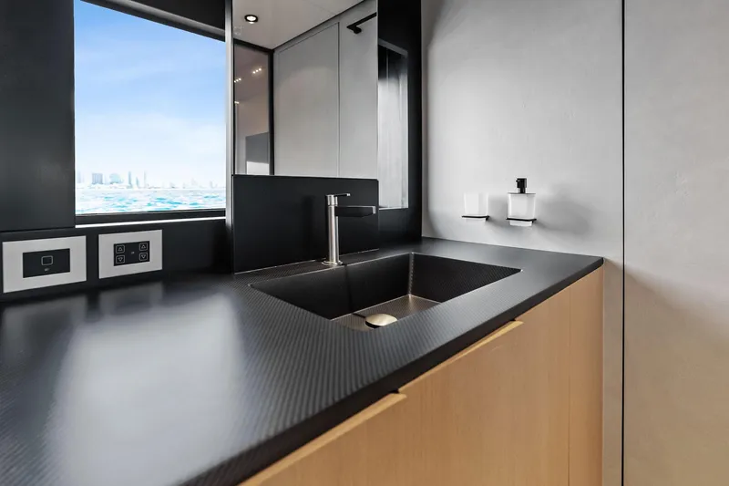 Another World Yacht Photos Pics Modern bathroom interior on 2025 Wally Wallytender 100 yacht, featuring sleek sink and ocean view.