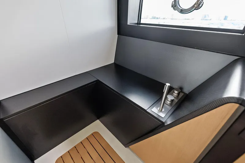 Another World Yacht Photos Pics Modern interior of 2025 Wally Wallytender 100 yacht with sleek seating and window view.
