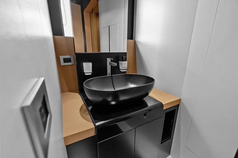 Another World Yacht Photos Pics Modern bathroom interior on 2025 Wally Wallytender 100 yacht, featuring sleek black basin.