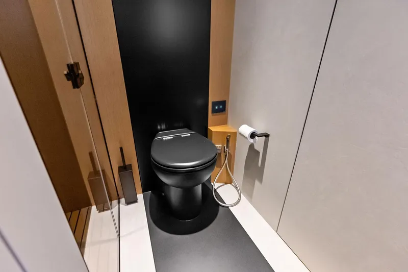 Another World Yacht Photos Pics Modern bathroom on 2025 Wally Wallytender 100 yacht with sleek black toilet.