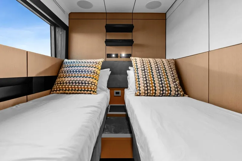 Another World Yacht Photos Pics Interior of 2025 Wally Wallytender 100 yacht with twin beds and geometric pillows.