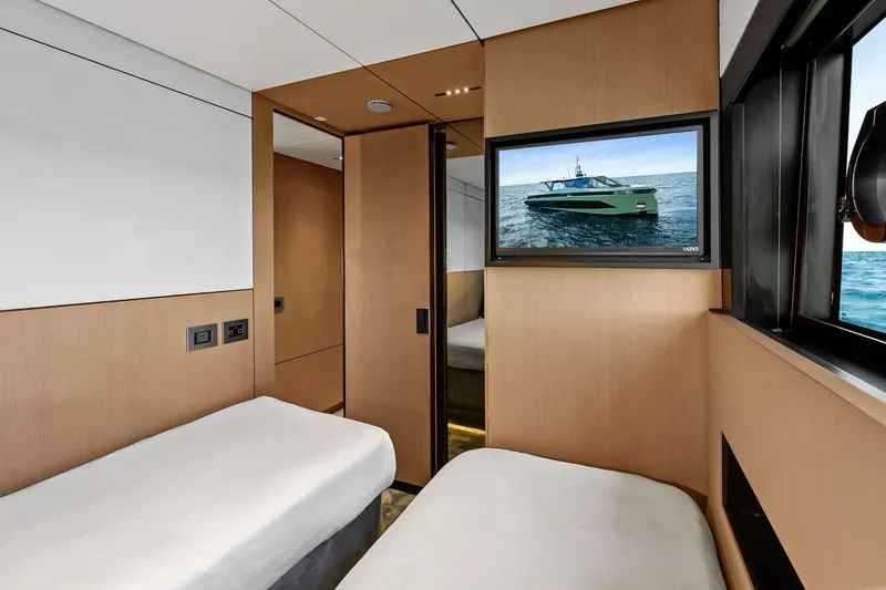 Another World Yacht Photos Pics Interior of 2025 Wally Wallytender 100 yacht with twin beds and TV.