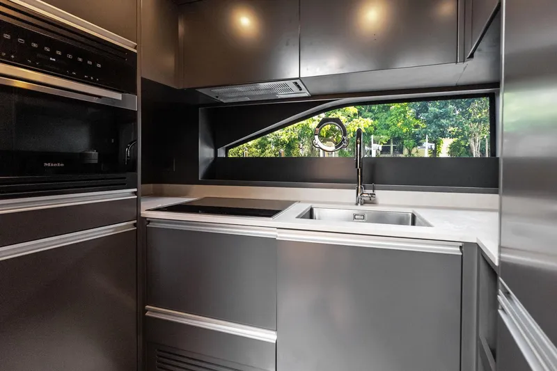 Another World Yacht Photos Pics Modern kitchen interior of 2025 Wally Wallytender 100 yacht with sleek design and appliances.