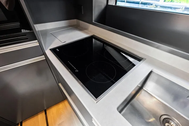 Another World Yacht Photos Pics Modern kitchen area in 2025 Wally Wallytender 100 yacht with sleek induction cooktop.