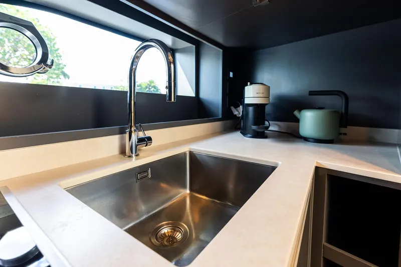Another World Yacht Photos Pics Modern kitchen sink area on 2025 Wally Wallytender 100 yacht, featuring sleek design elements.