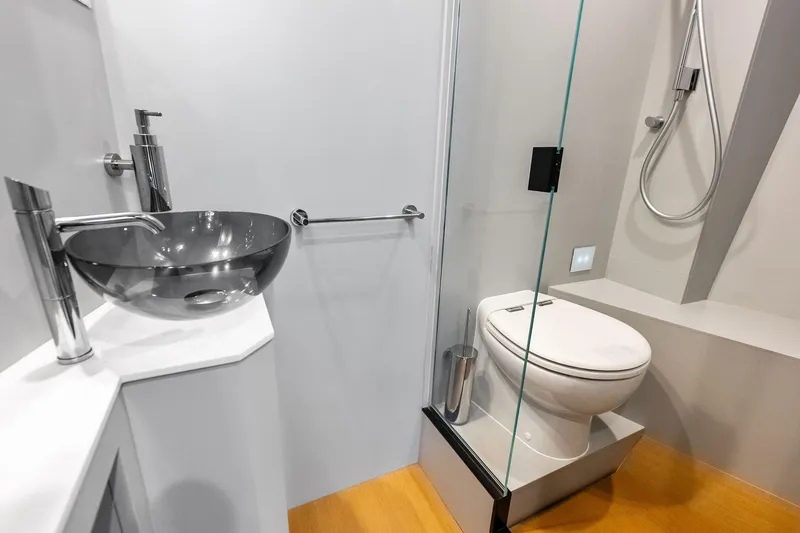 Another World Yacht Photos Pics Modern bathroom on 2025 Wally Wallytender 100 yacht with sleek fixtures and glass shower.