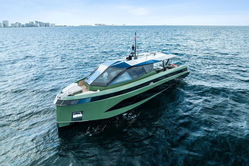 Another World Yacht Photos Pics 2025 Wally Wallytender 100 yacht cruising on open sea with city skyline in background.