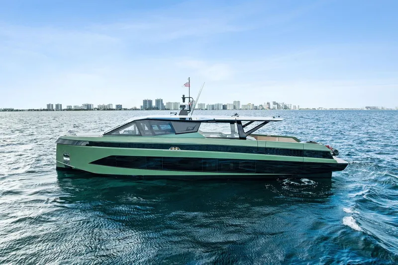 Another World Yacht Photos Pics 2025 Wally Wallytender 100 yacht on open water with city skyline backdrop.