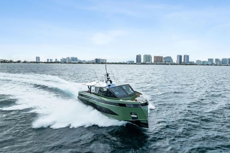 Another World Yacht Photos Pics 2025 Wally Wallytender 100 yacht cruising on open water near city skyline.