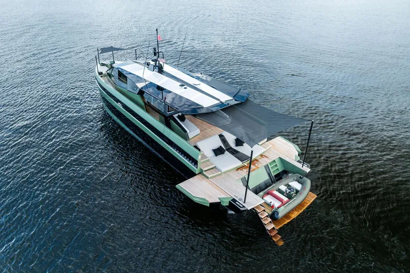 Another World Yacht Photos Pics Luxurious 2025 Wally Wallytender 100 yacht on serene water, featuring sleek design and spacious deck.