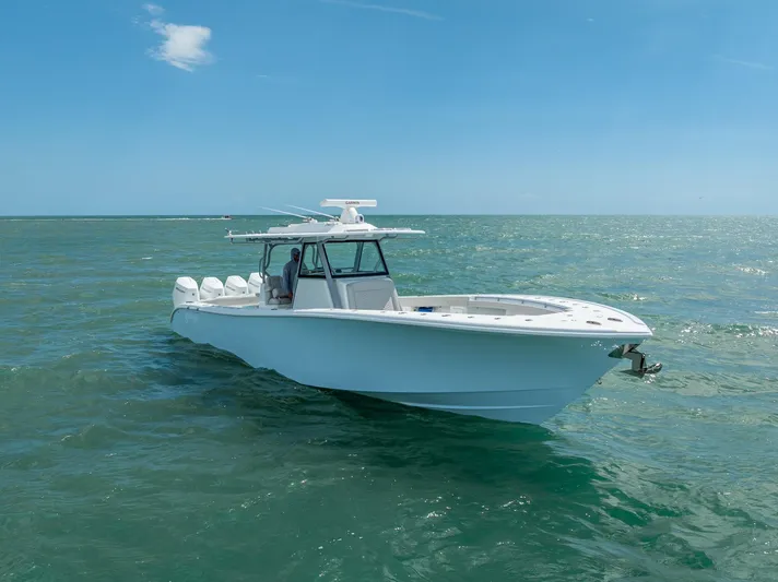  Yacht Photos Pics 2024 Yellowfin 39 boat cruising on open sea under clear blue sky.