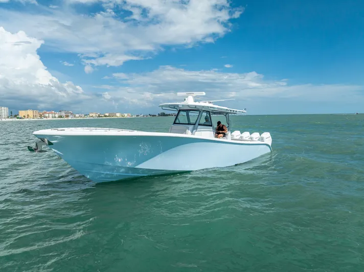  Yacht Photos Pics 2024 Yellowfin 39 boat cruising on open water under a clear blue sky.