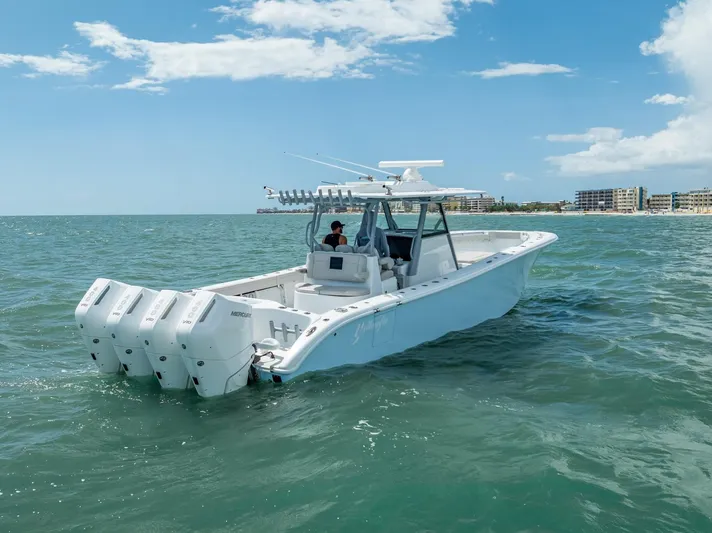  Yacht Photos Pics 2024 Yellowfin 39 boat with four engines cruising on open water.