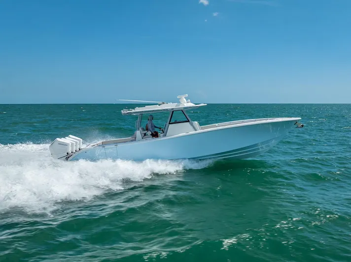  Yacht Photos Pics 2024 Yellowfin 39 boat cruising on open sea under clear blue sky.
