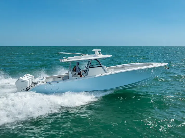  Yacht Photos Pics 2024 Yellowfin 39 boat cruising on open sea under clear blue sky.