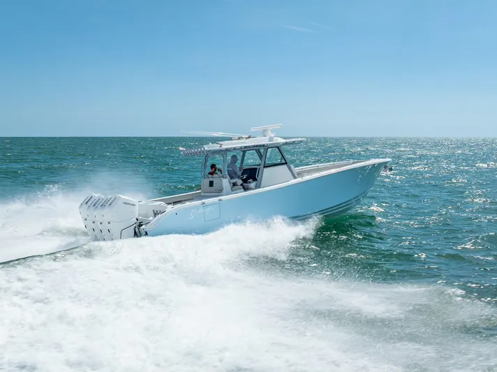  Yacht Photos Pics 2024 Yellowfin 39 boat cruising on open sea under clear blue sky.