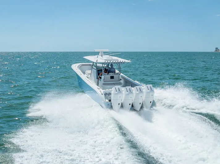  Yacht Photos Pics 2024 Yellowfin 39 boat cruising on open water with four powerful engines.