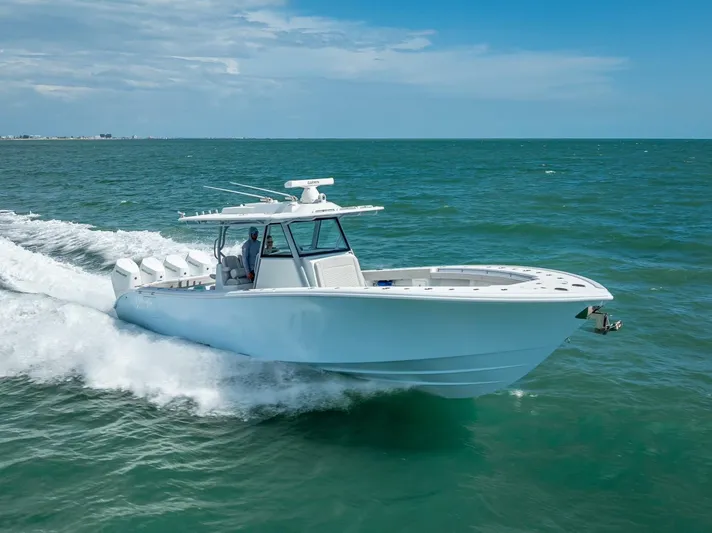  Yacht Photos Pics 2024 Yellowfin 39 boat cruising on open water under a clear blue sky.