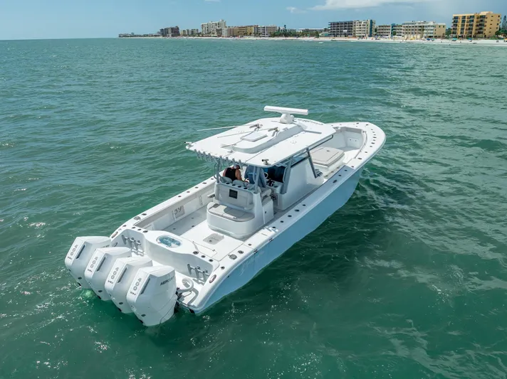  Yacht Photos Pics 2024 Yellowfin 39 boat cruising on ocean near coastal buildings.