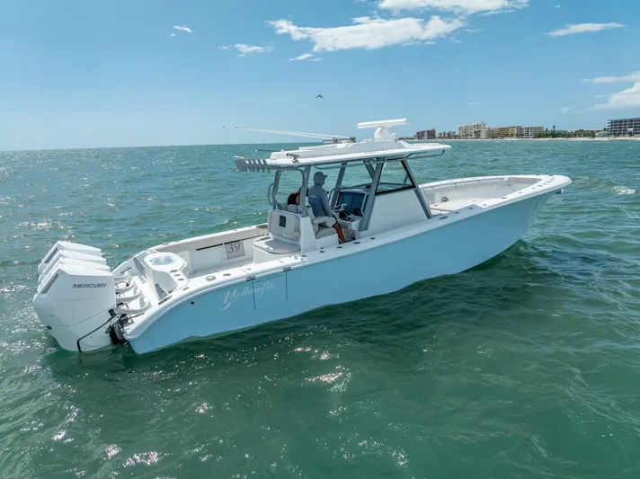  Yacht Photos Pics 2024 Yellowfin 39 boat cruising on open water under a clear blue sky.