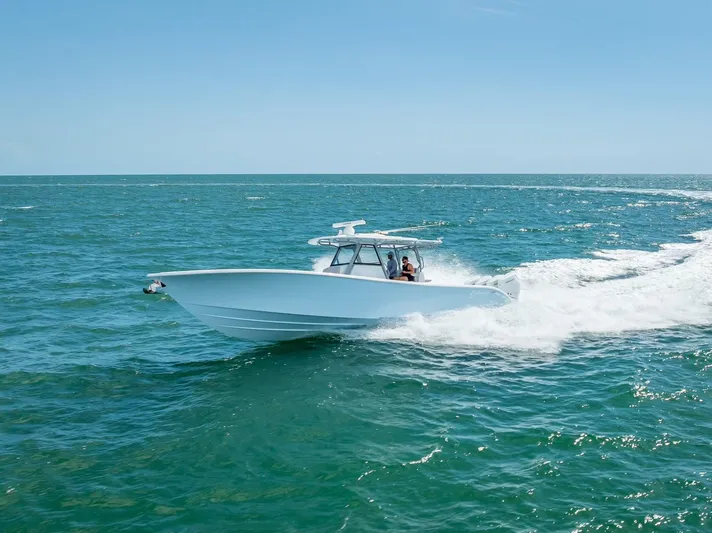  Yacht Photos Pics 2024 Yellowfin 39 boat cruising on open ocean waters.