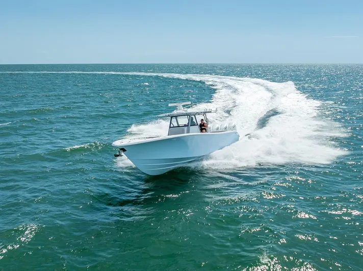  Yacht Photos Pics 2024 Yellowfin 39 boat cruising on open ocean waters.