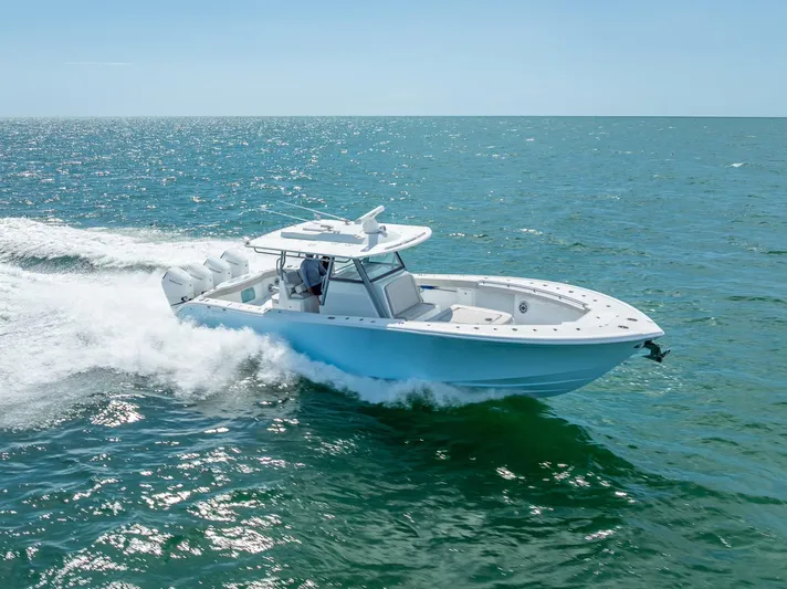  Yacht Photos Pics 2024 Yellowfin 39 boat cruising on open sea under clear blue sky.