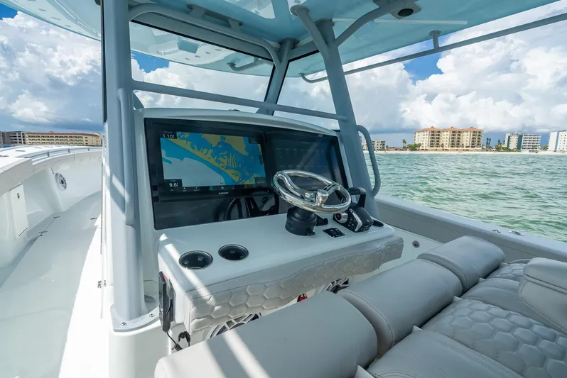  Yacht Photos Pics 2024 Yellowfin 39 boat cockpit with navigation screens, steering wheel, and ocean view.