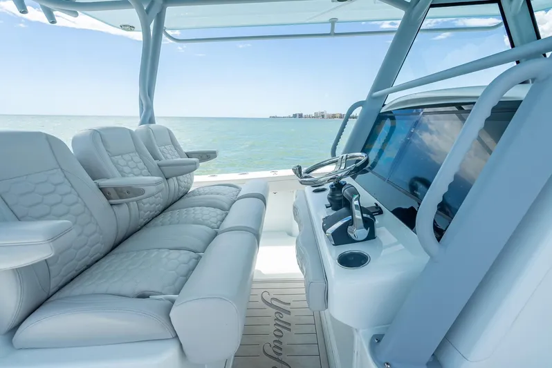  Yacht Photos Pics 2024 Yellowfin 39 boat interior with luxurious seating and modern helm, overlooking the ocean.