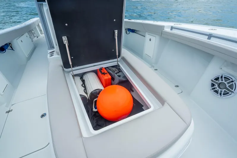  Yacht Photos Pics 2024 Yellowfin 39 boat storage compartment with safety equipment and gear.