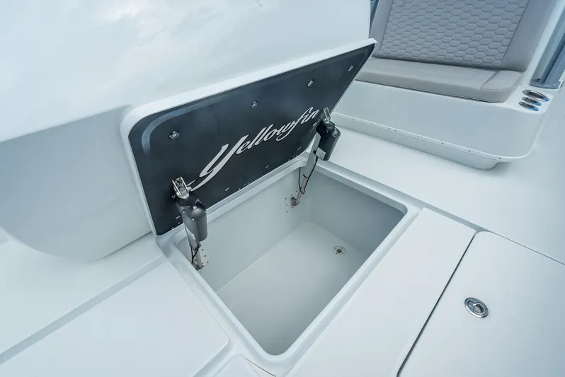  Yacht Photos Pics 2024 Yellowfin 39 boat storage compartment with open lid, showcasing interior space.