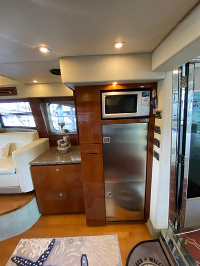 Dream Chaser Yacht Photos Pics 2008 Sea Ray 47 Sedan Bridge interior with modern kitchen appliances and elegant wood finish.