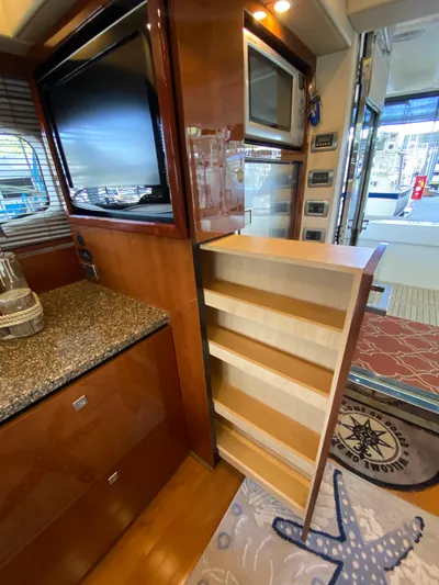 Dream Chaser Yacht Photos Pics Interior of 2008 Sea Ray 47 Sedan Bridge with pull-out storage and modern appliances.