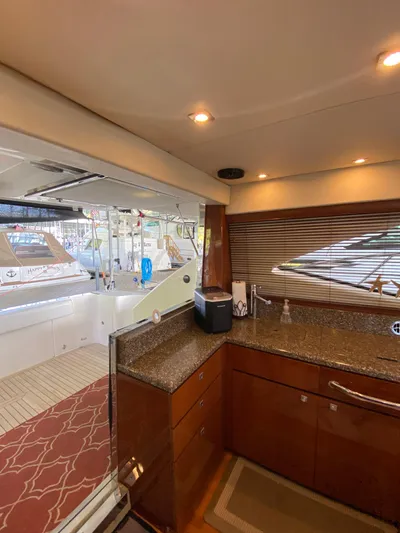 Dream Chaser Yacht Photos Pics Interior view of 2008 Sea Ray 47 Sedan Bridge yacht kitchen area with granite countertops.