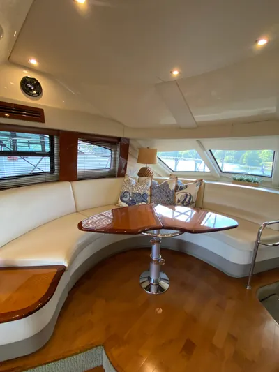 Dream Chaser Yacht Photos Pics 2008 Sea Ray 47 Sedan Bridge interior with elegant seating and wooden table.