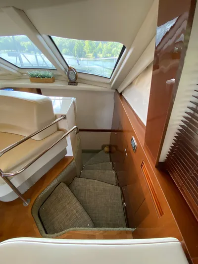 Dream Chaser Yacht Photos Pics Interior of 2008 Sea Ray 47 Sedan Bridge, featuring stairs and seating area.