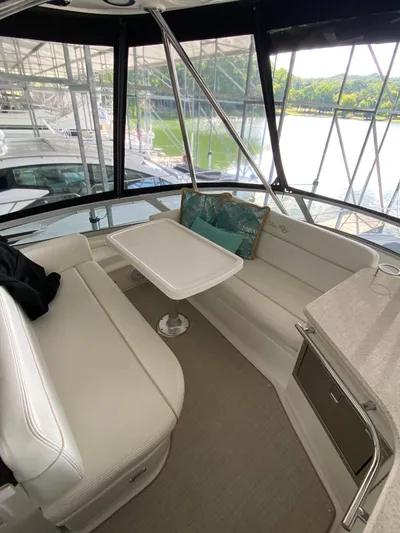 Dream Chaser Yacht Photos Pics 2008 Sea Ray 47 Sedan Bridge interior with white seating, table, and scenic marina view.