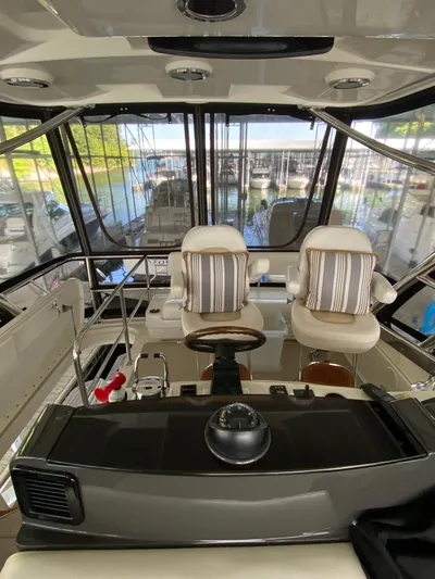 Dream Chaser Yacht Photos Pics 2008 Sea Ray 47 Sedan Bridge helm with striped cushions, overlooking marina.